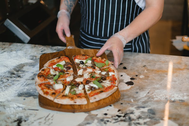 Jet's pizza kitchen with handcrafted pizza being prepared